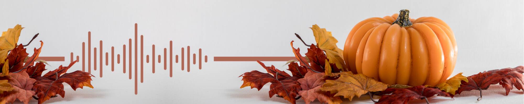 A pumpkin with fallen leaves.